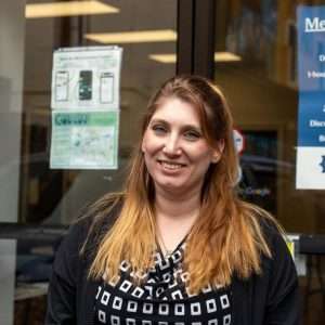 erica Boone, community manager of covation center standing in front of the glass doors at the entrance