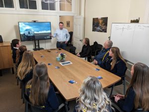 an image of a group of people sitting in the meeting room at the Covation Center, listening to a presentation